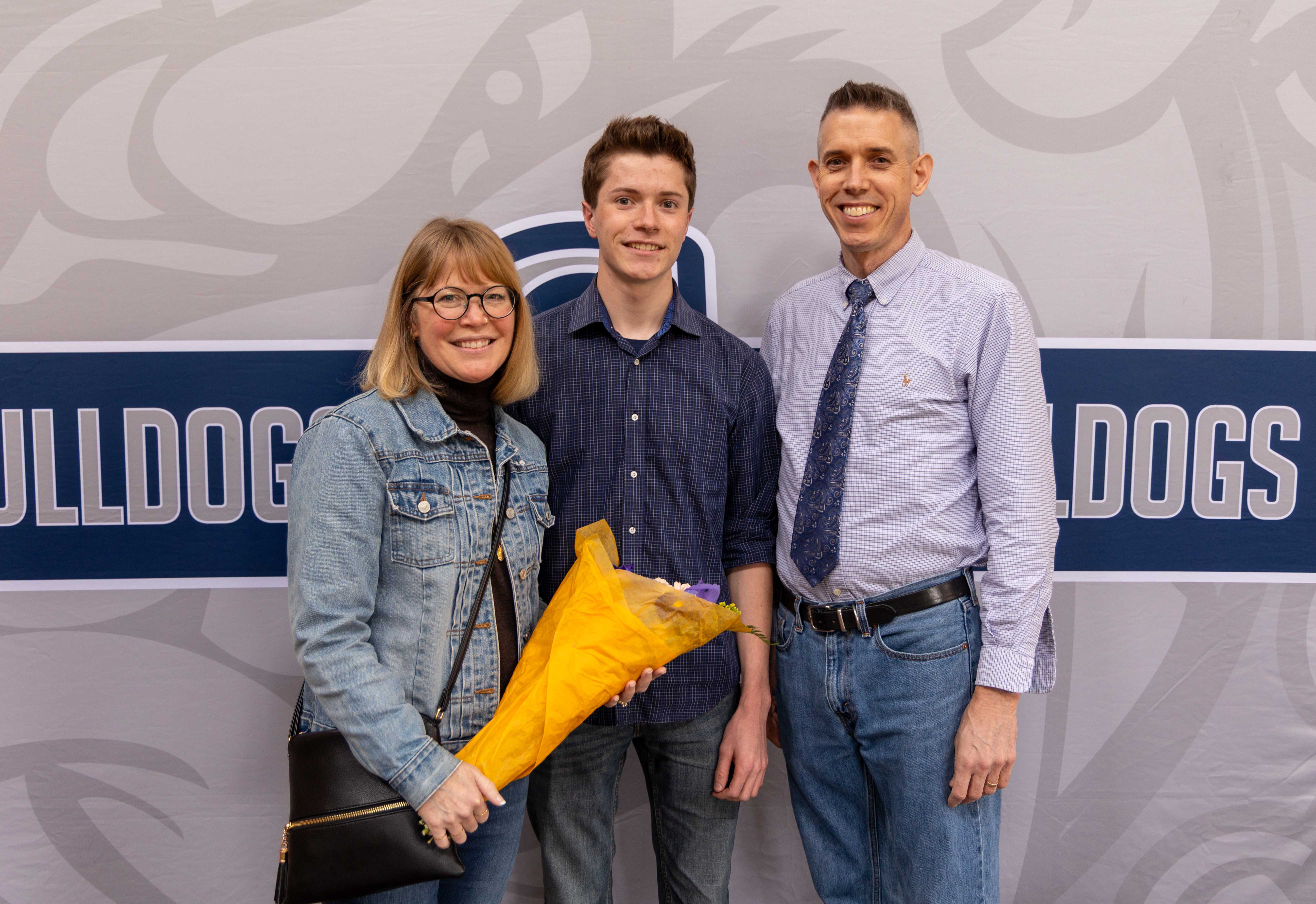 John Hopkins poses with his parents, Adrienne and Matthew
